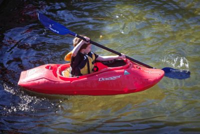 Child Learning How To Do Kayak Strokes